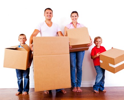 Local movers packing fragile household items with care