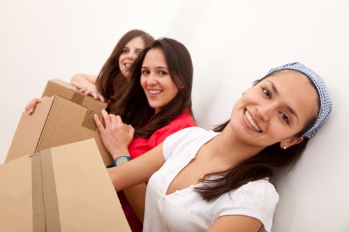 Local office moving team transporting desks and IT equipment in Beckenham